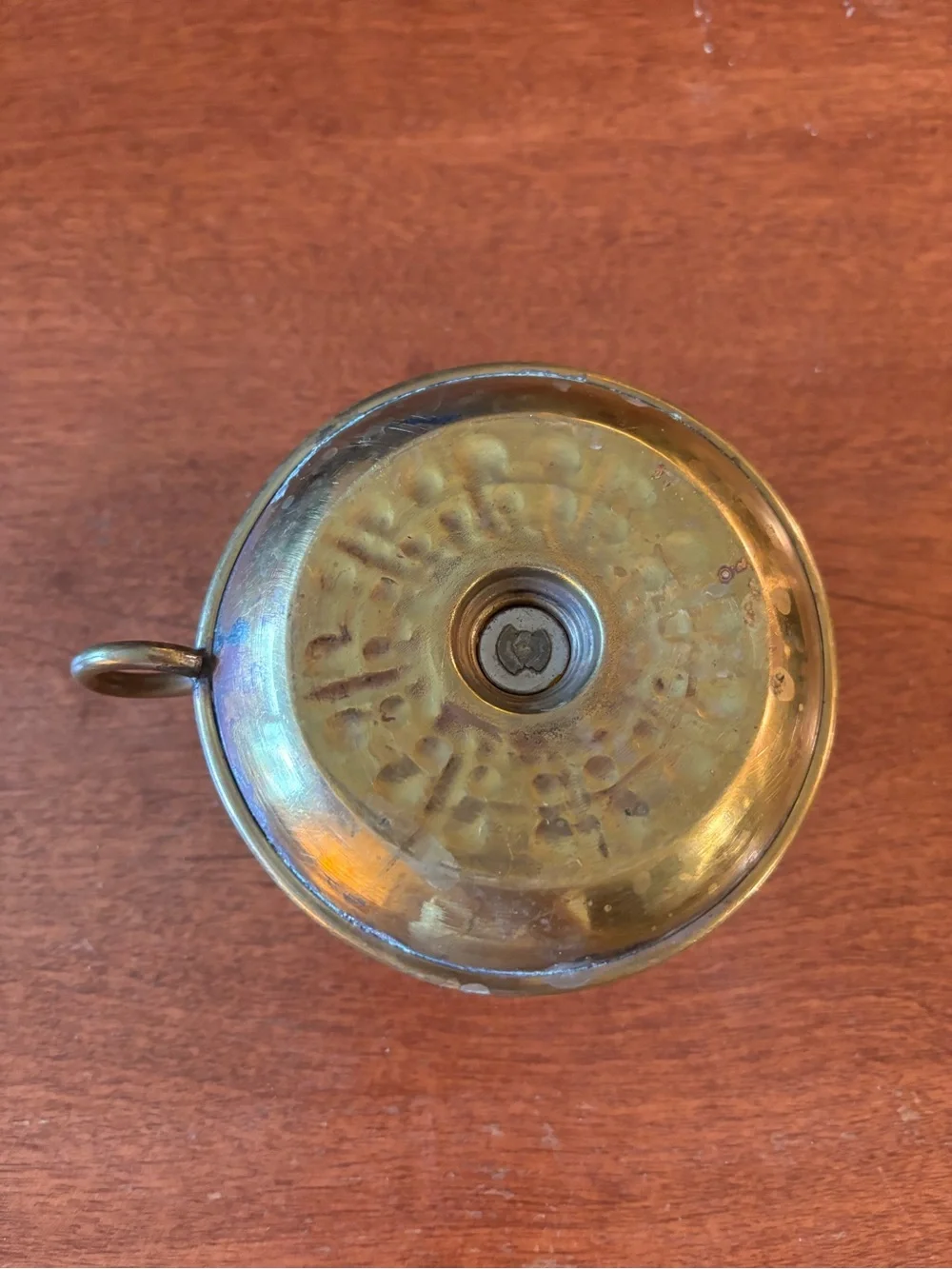 vintage brass chamberstick candle holder with a circular base and a ring handle